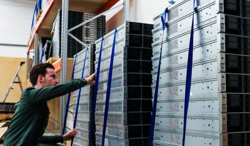 Man fixing a stack of refurbished servers