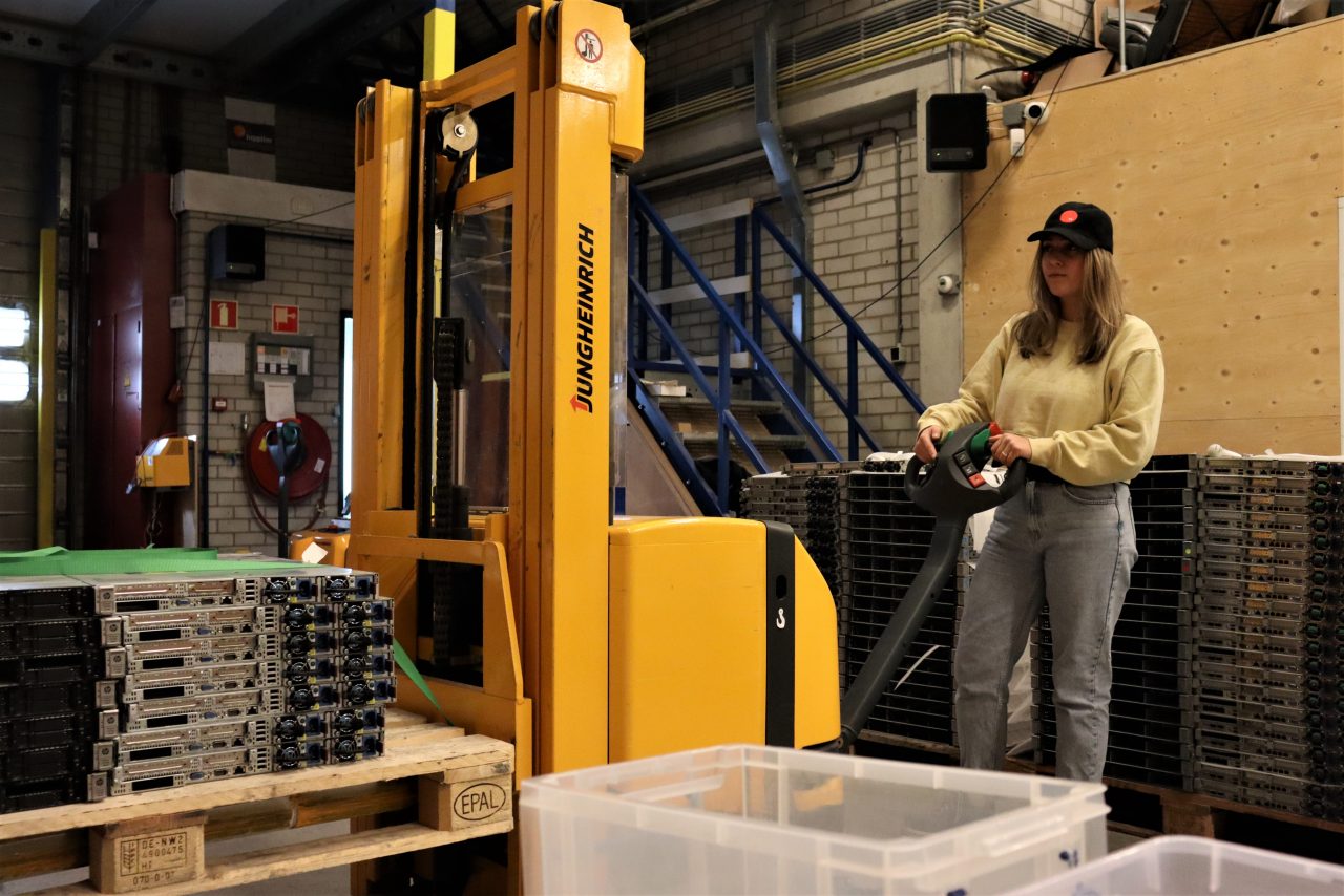 Woman stacking refurbished servers for sale